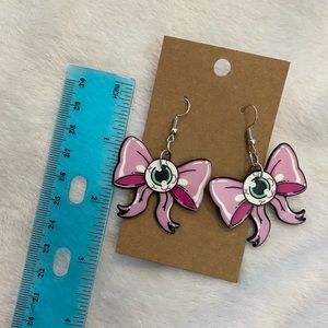 Pink bow with eyeballs earrings